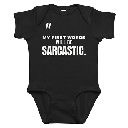 Black baby bodysuit with My First Words Will Be Sarcastic printed in white on the front