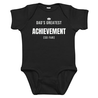 Black baby bodysuit with Dad's Greatest Achievement printed in white on the front