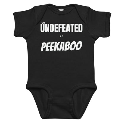 Black baby bodysuit with Undefeated At Peekaboo printed in white on the front