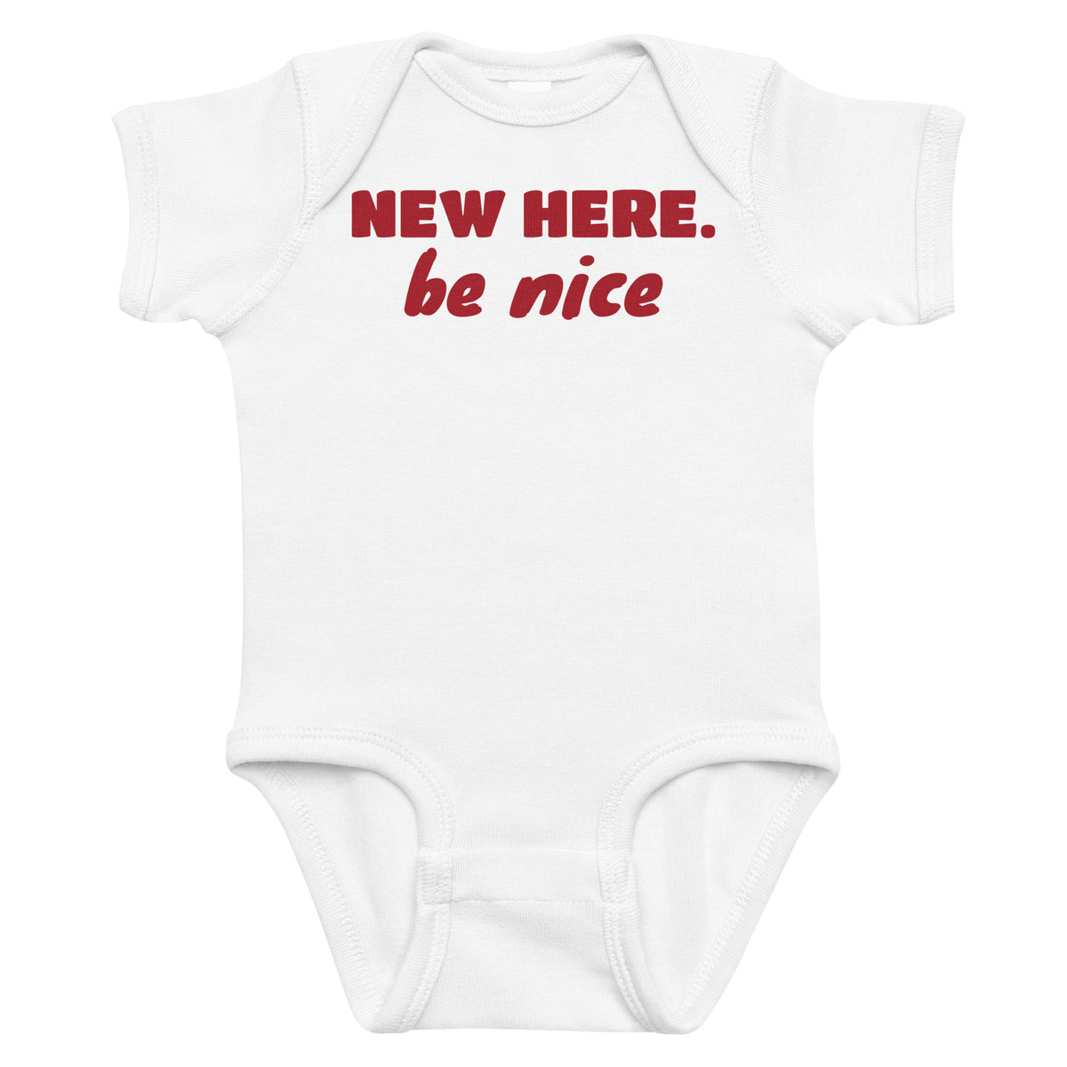 Back view of the black baby bodysuit with New Here Be Nice printed on the front