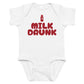 White baby bodysuit with Milk Drunk printed in red on the front