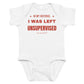 White baby bodysuit with In My Defense, I Was Left Unsupervised printed in red on the front