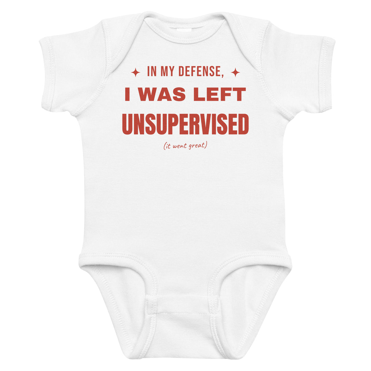 White baby bodysuit with In My Defense, I Was Left Unsupervised printed in red on the front