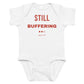 White baby bodysuit with Still Buffering printed in red on the front