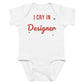 White baby bodysuit with I Cry In Designer printed in red on the front