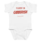 White baby bodysuit with Fluent In Gibberish printed in red on the front