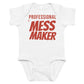 White baby bodysuit with Professional Mess Maker printed in red on the front
