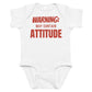 White baby bodysuit with Warning: May Contain Attitude printed in red on the front