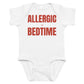 White baby bodysuit with Allergic To Bedtime printed in red on the front