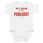 White baby bodysuit with My Mom Is My Publicist printed in red on the front