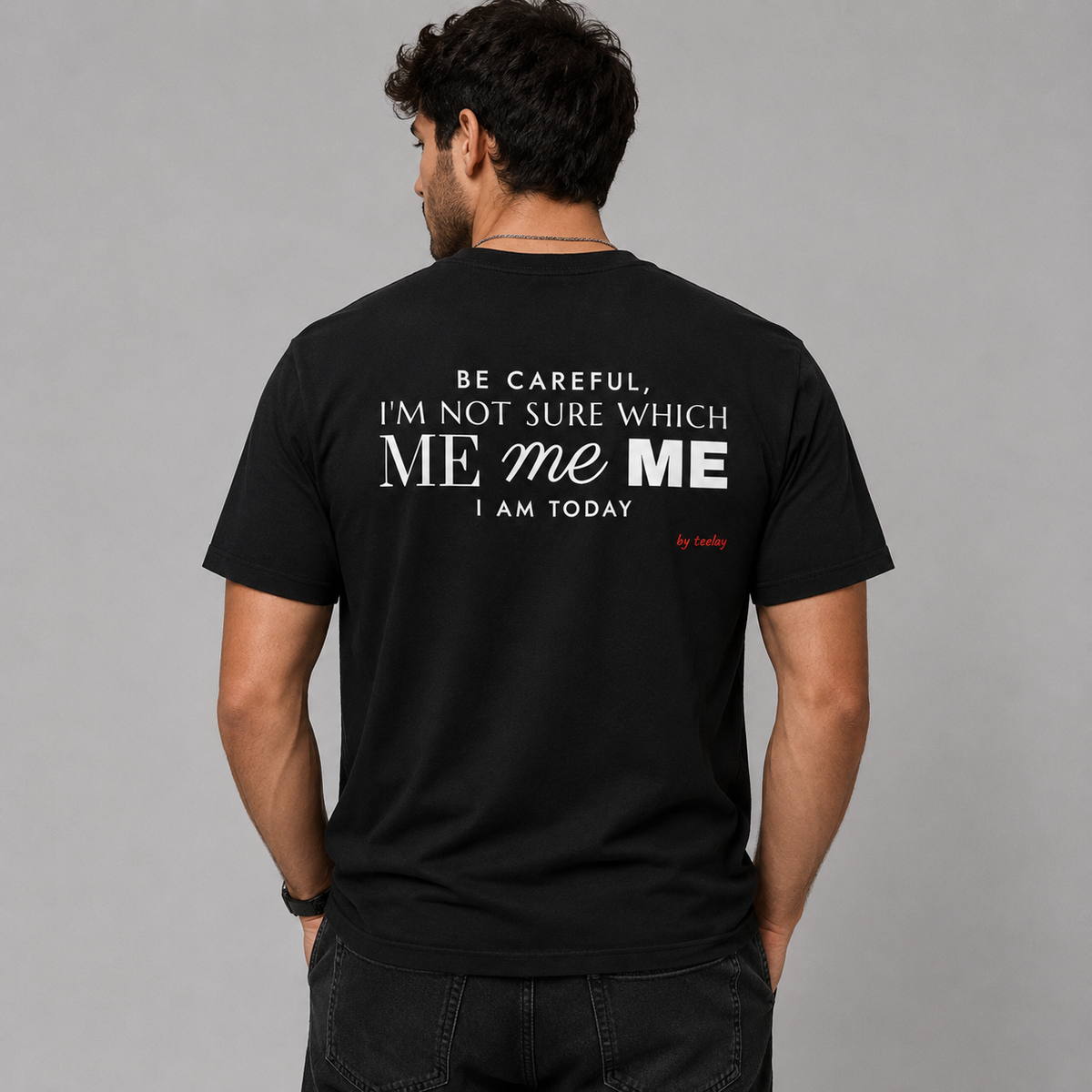 Man from behind wearing a black t shirt with Be Careful I'm Not Sure Which Me I Am Today printed on the back