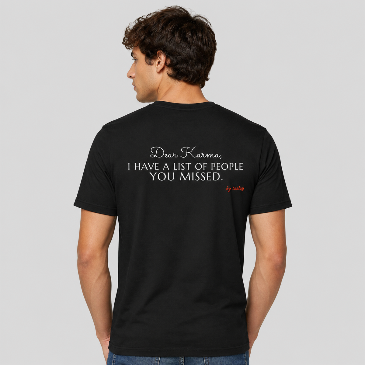 Man from behind wearing a black t shirt with Dear Karma I Have A List Of People You Missed printed on the back