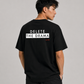Man from behind wearing a black t shirt with Delete The Drama printed on the back