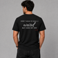 Man from behind wearing a black t shirt with Didn't Mean To Make It Weird But Here We Are printed on the back