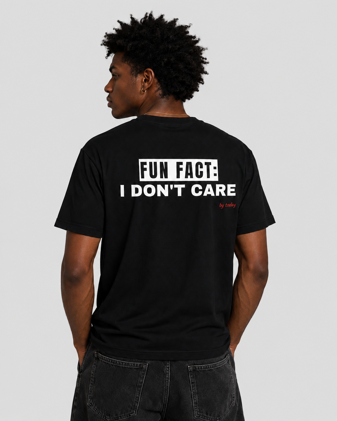 Man from behind wearing a black t shirt with Fun Fact I Don't Care printed on the back