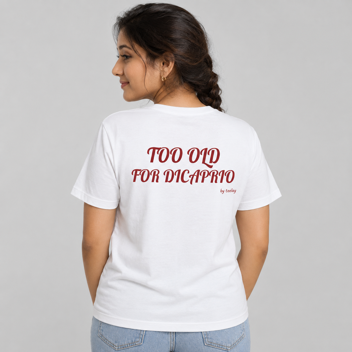 Woman from behind wearing a white t shirt with a funny age joke printed on the back