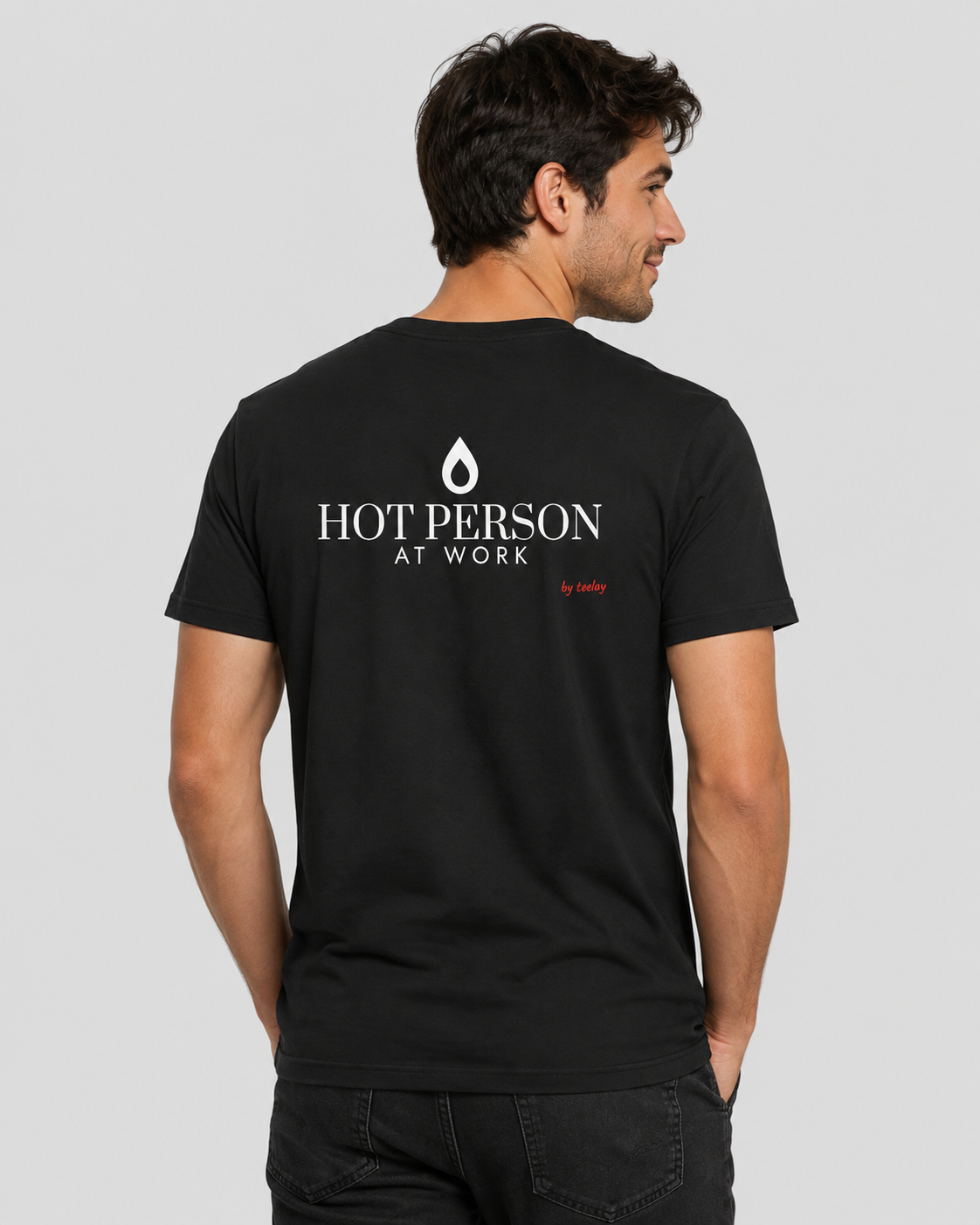 Man from behind wearing a black t shirt with Hot Person At Work printed on the back