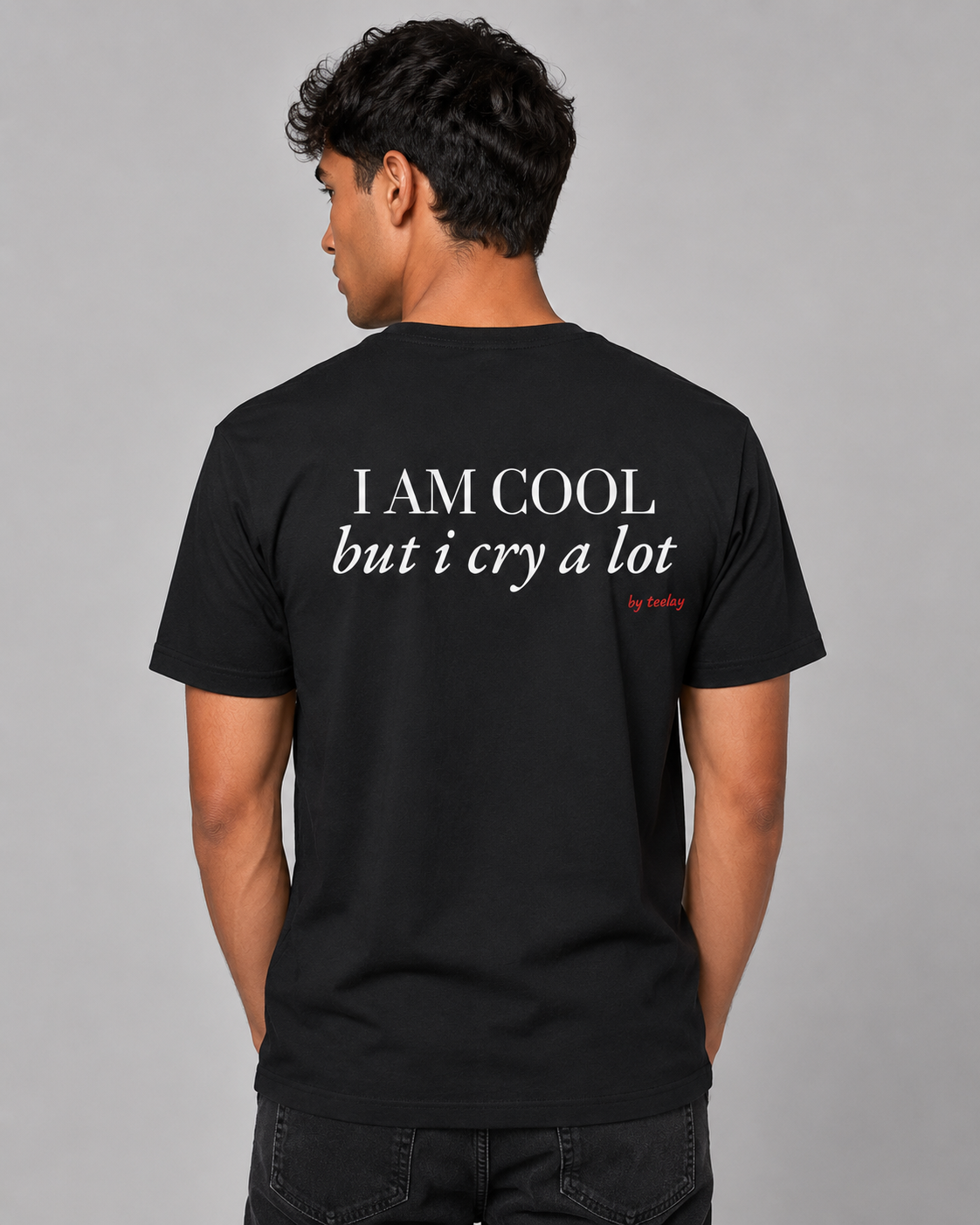 Man from behind wearing a black t shirt with I Am Cool But I Cry A Lot printed on the back