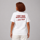 Woman from behind wearing a white t shirt with I Don't Make Mistakes I Date Them printed on the back