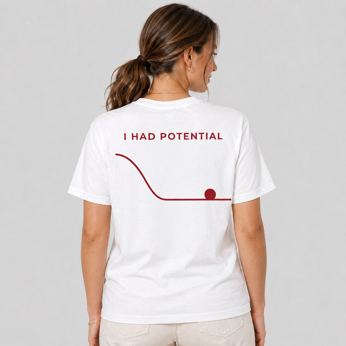 Woman from behind wearing a white t shirt with I Had Potential and a falling graph printed on the back