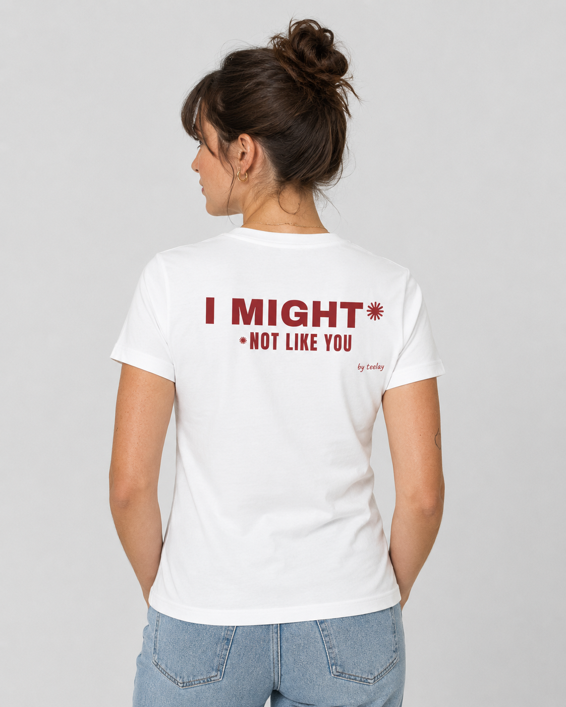 Woman from behind wearing a white t shirt with I Might Not Like You printed on the back