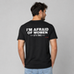 Man from behind wearing a black t shirt with I'm Afraid Of Women It's True printed on the back