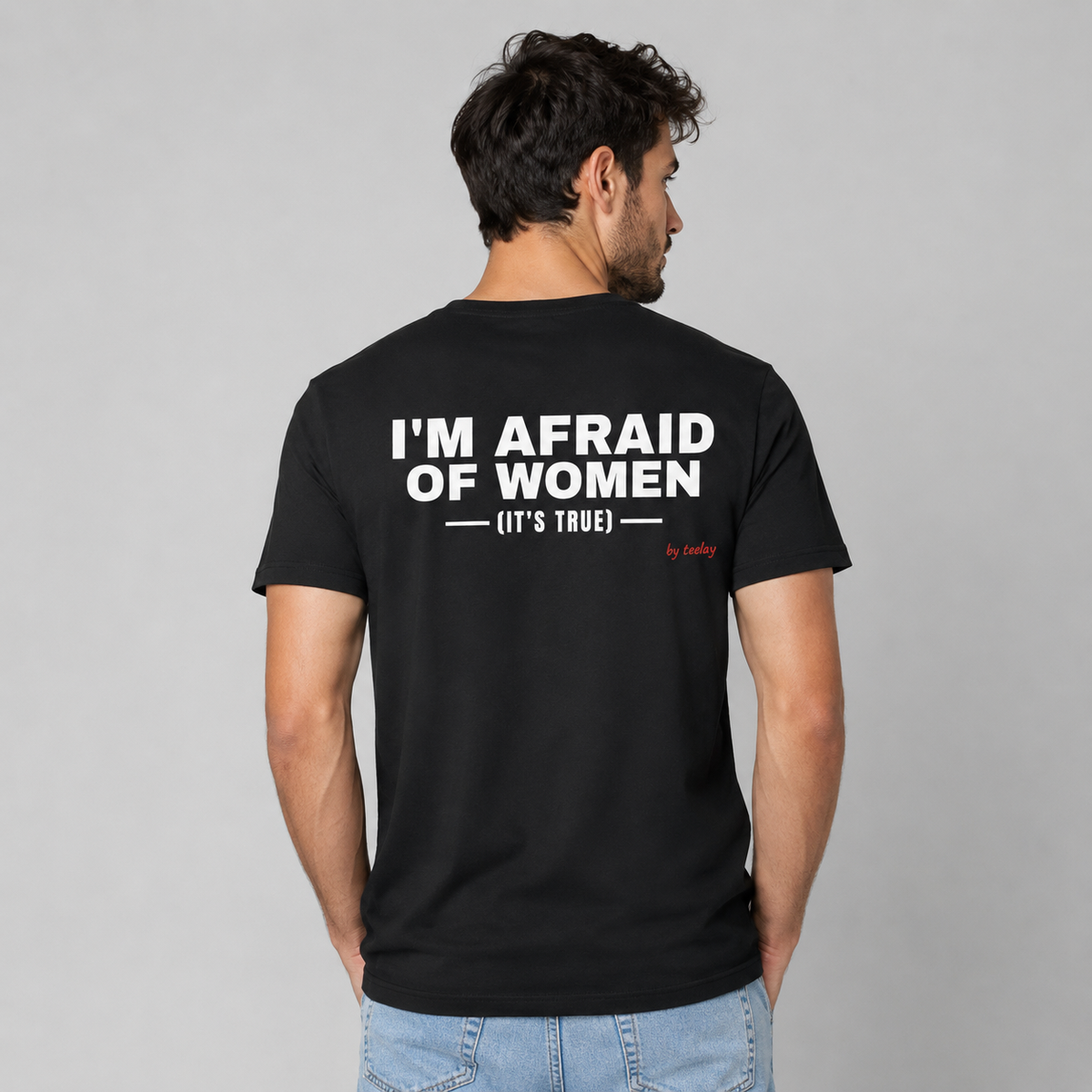 Man from behind wearing a black t shirt with I'm Afraid Of Women It's True printed on the back