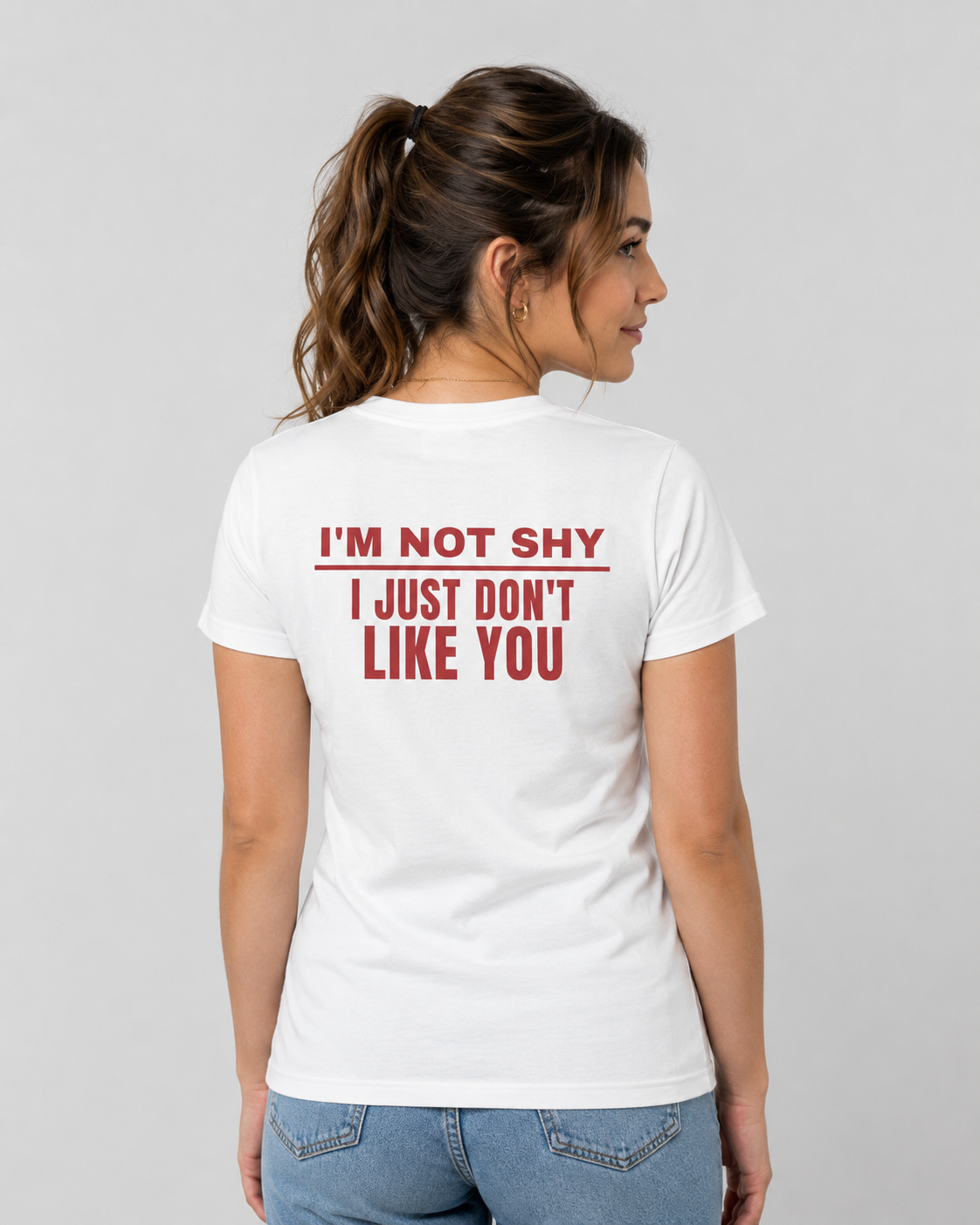 Woman from behind wearing a white t shirt with I'm Not Shy I Just Don't Like You printed on the back