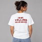 Woman from behind wearing a white t shirt with I'm Not Yelling This Is My Mom Voice printed on the back