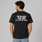 Man wearing a black funny tee with I'm So Sexy That Even Life Gets Hard printed on the back, rear view