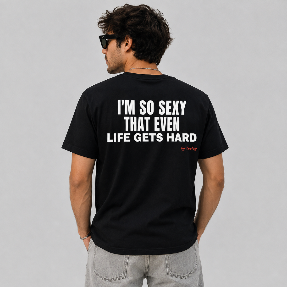 Man from behind wearing a black t shirt with I'm So Sexy That Even Life Gets Hard printed on the back