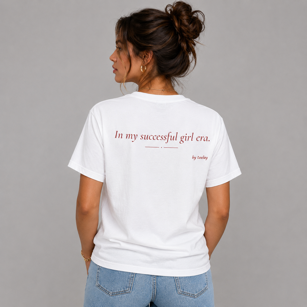 Woman from behind wearing a white t shirt with In My Successful Girl Era printed on the back