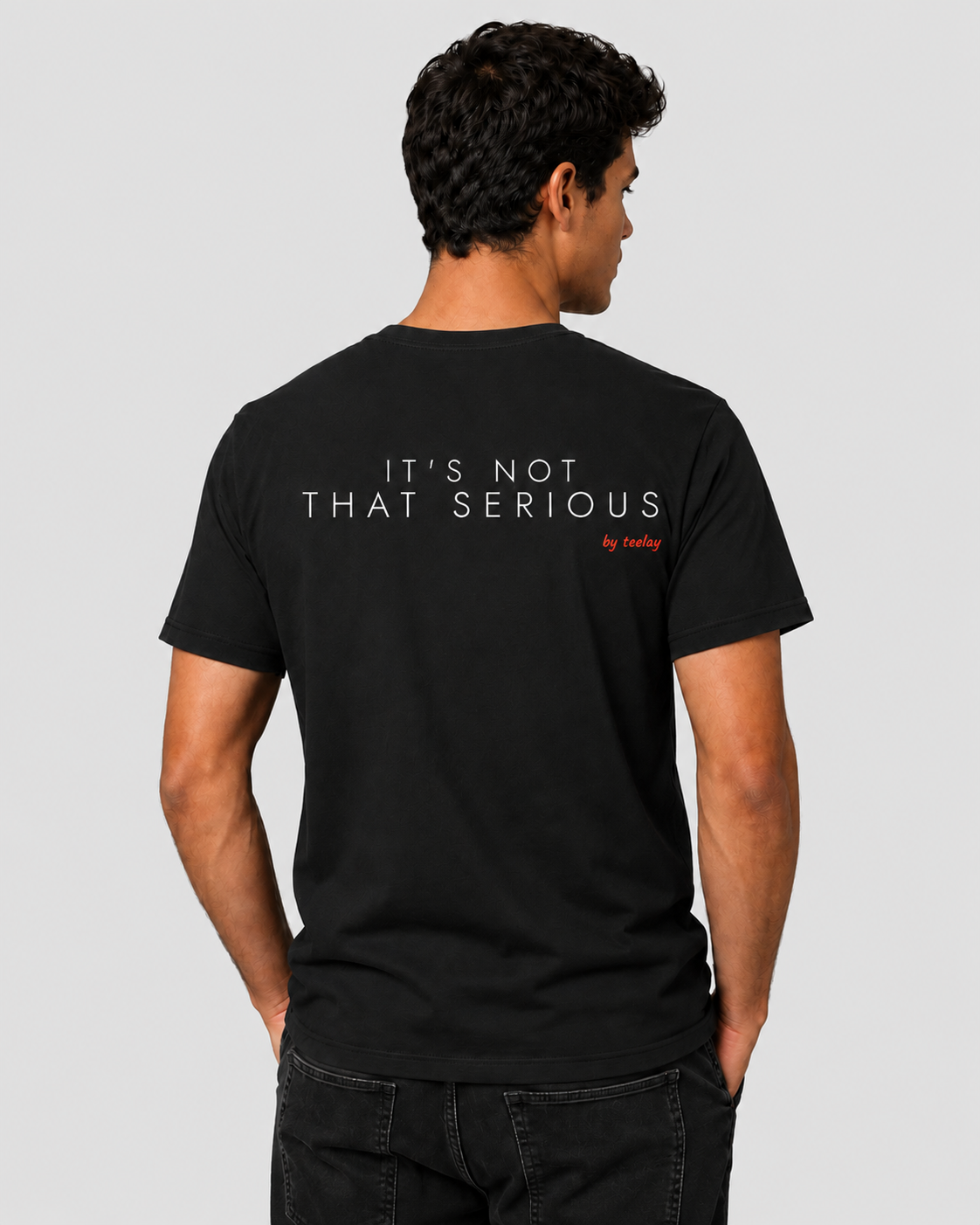 Man from behind wearing a black t shirt with It's Not That Serious printed on the back