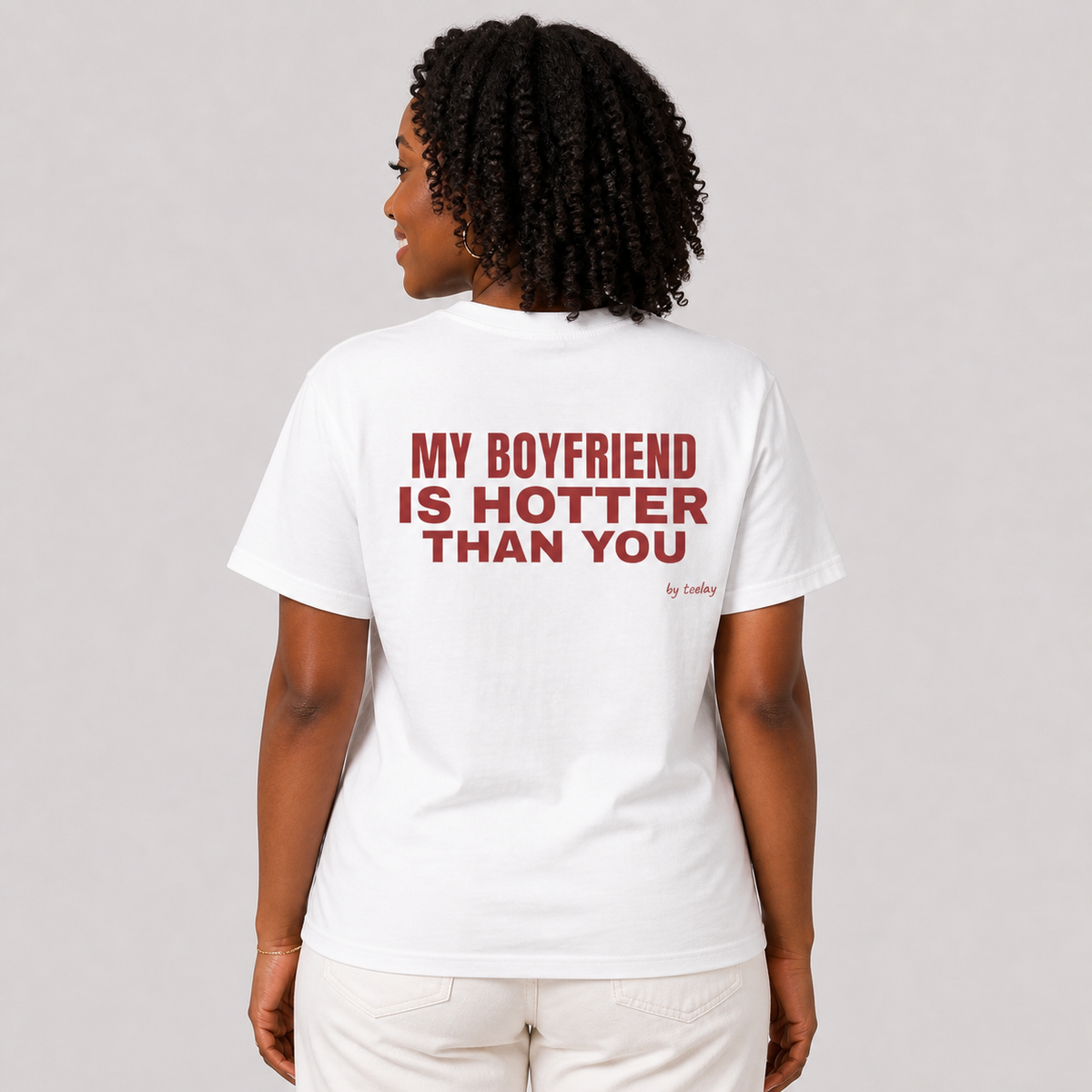 Woman from behind wearing a white t shirt with My Boyfriend Is Hotter Than You printed on the back