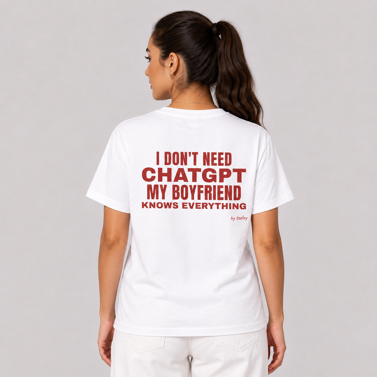 Woman from behind wearing a white t shirt with My Boyfriend Knows Everything printed on the back