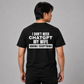 Man wearing a black graphic tee with My Wife Knows Everything printed on the back, rear view