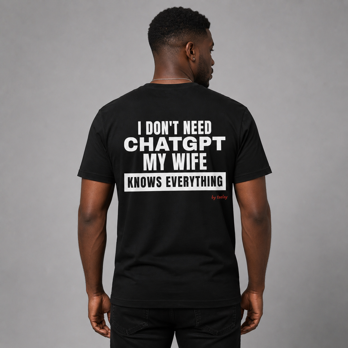 Man from behind wearing a black t shirt with My Wife Knows Everything printed on the back