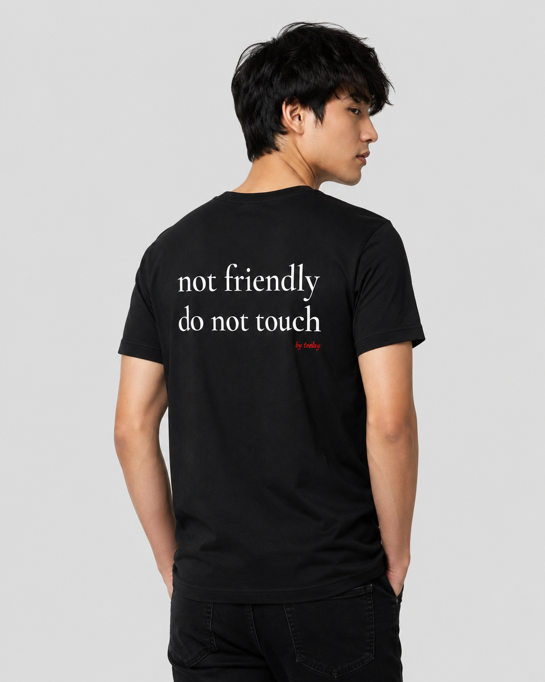 Man from behind wearing a black t shirt with Not Friendly Do Not Touch printed on the back