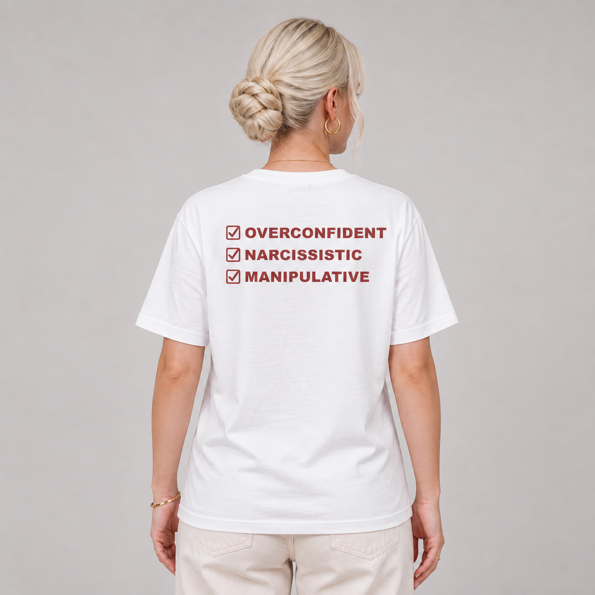 Woman from behind wearing a white t shirt with Overconfident Narcissistic Manipulative checklist printed on the back