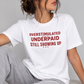 Overstimulated. Underpaid. Still Showing Up. Tee for Women