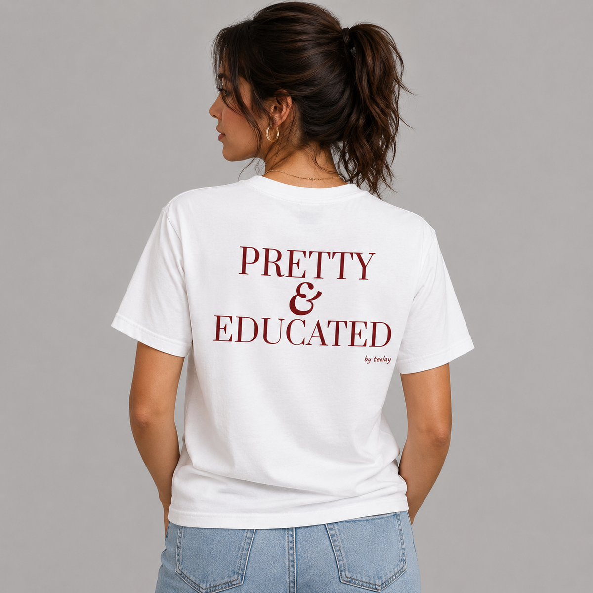 Woman from behind wearing a white t shirt with Pretty And Educated printed on the back