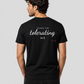 Man from behind wearing a black t shirt with Thanks For Tolerating Me printed on the back