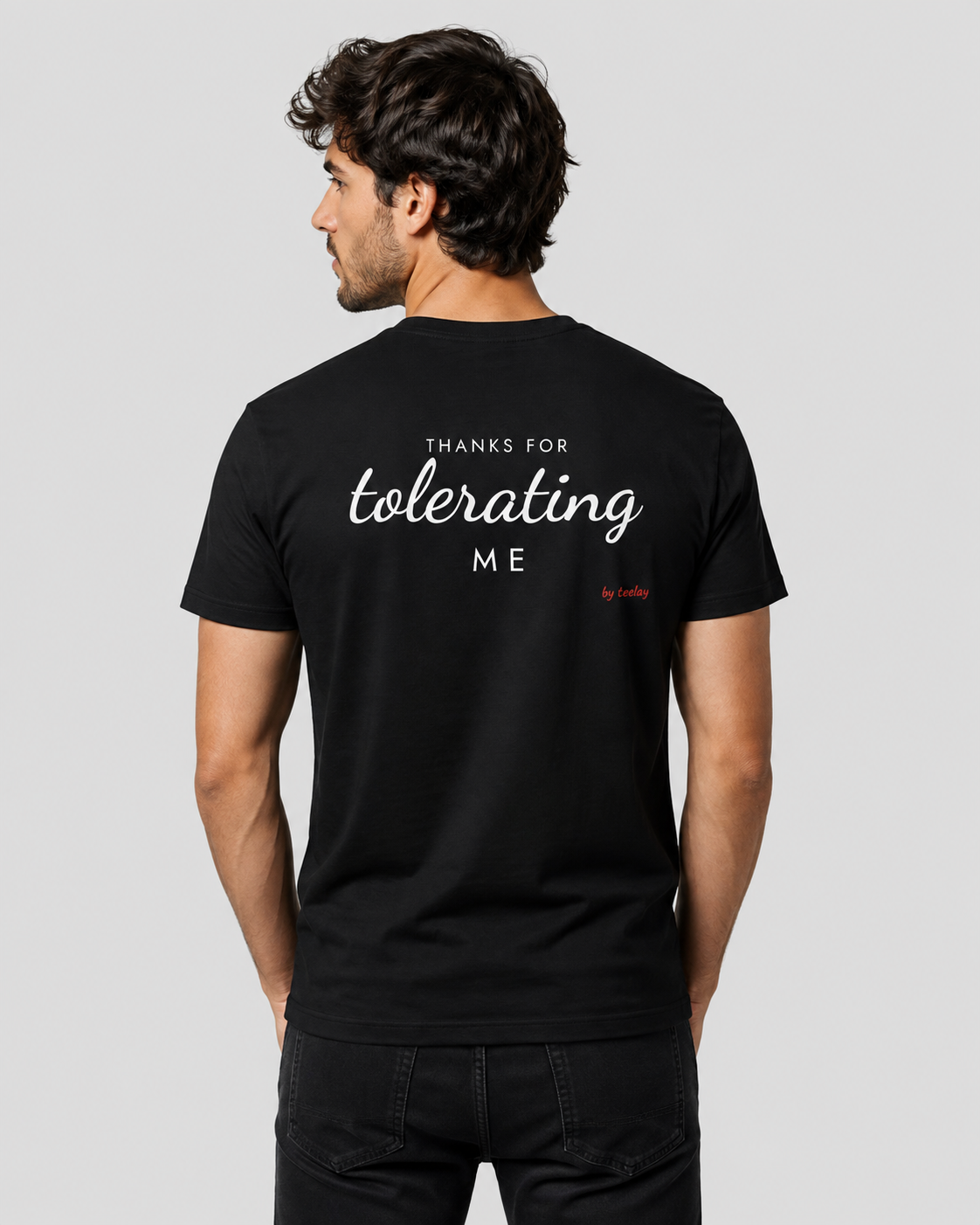 Man from behind wearing a black t shirt with Thanks For Tolerating Me printed on the back