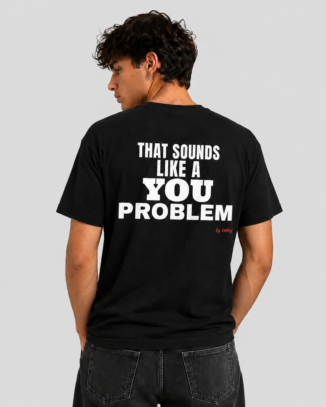 Man from behind wearing a black t shirt with That Sounds Like A You Problem printed on the back