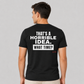 Man wearing a black funny tee with That's A Horrible Idea What Time printed on the back, rear view