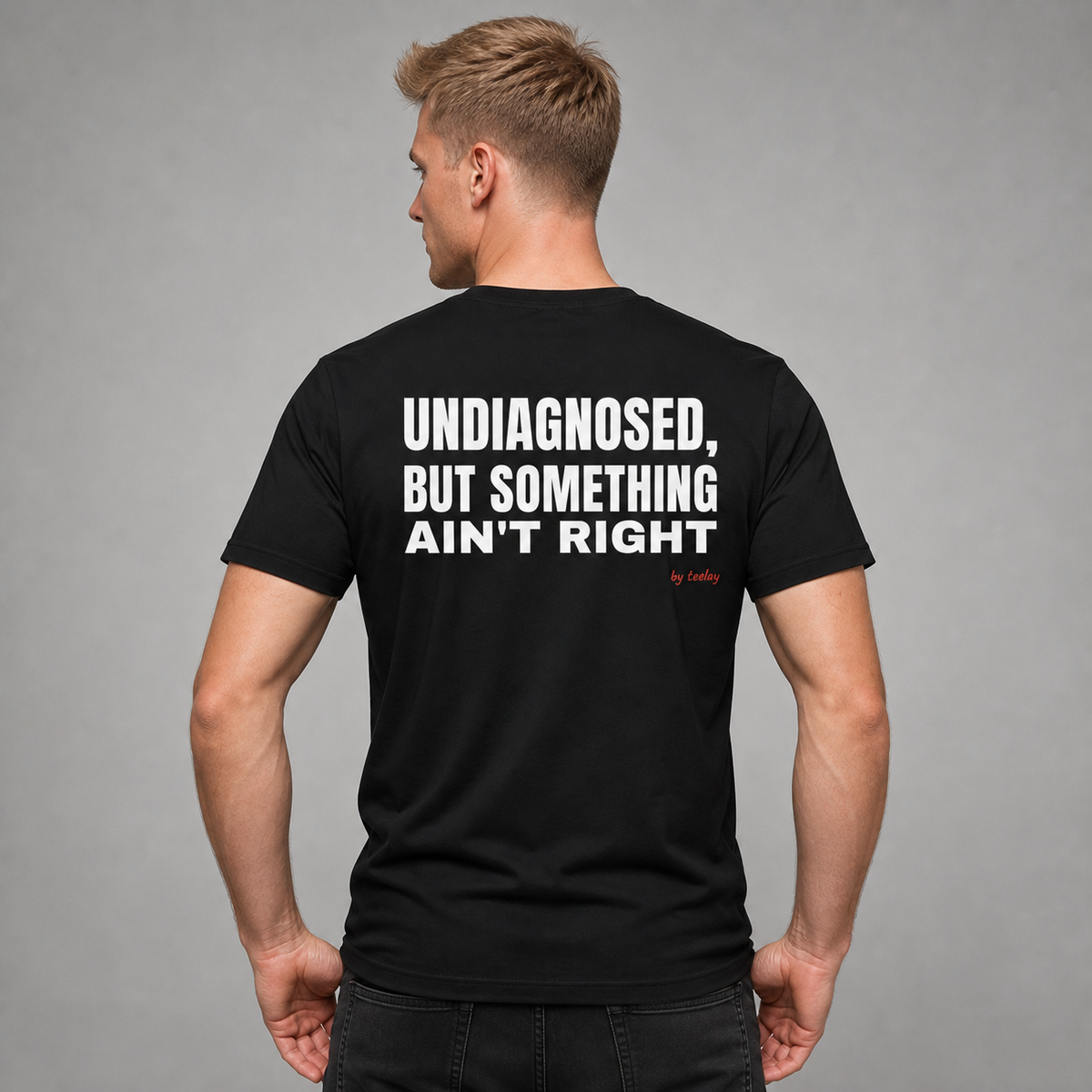 Man from behind wearing a black t shirt with Undiagnosed But Something Ain't Right printed on the back