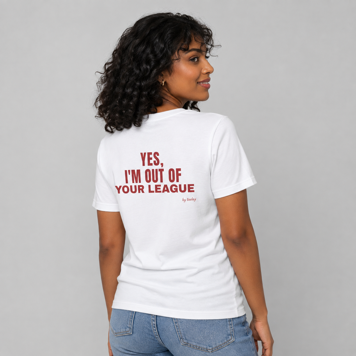 Woman from behind wearing a white t shirt with Yes I'm Out Of Your League printed on the back
